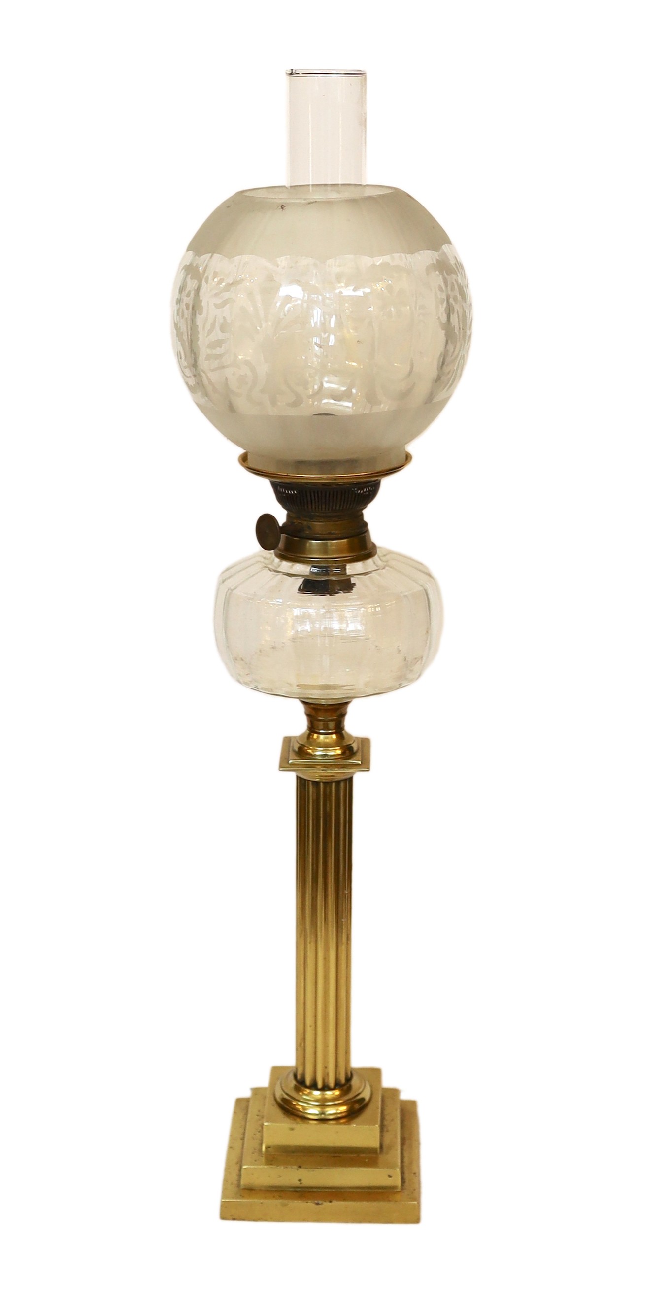 An Edwardian brass oil lamp with lobed glass reservoir, frosted globe and flue, height overall 74cm